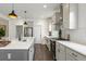 Well-lit kitchen featuring stainless steel appliances, white cabinets, pendant lighting, and quartz countertops at 518 Sound Dr, Summerville, SC 29486
