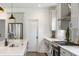 New kitchen features modern stainless steel appliances, white cabinets, quartz countertops, and wood flooring at 518 Sound Dr, Summerville, SC 29486