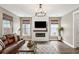 Cozy living room features a fireplace, shiplap accent wall, and a comfortable leather sofa at 518 Sound Dr, Summerville, SC 29486