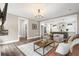 Open-concept living room showcases hardwood floors and stylish decor with a view into the modern kitchen at 518 Sound Dr, Summerville, SC 29486