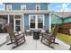 Relaxing patio with rocking chairs and fire pit, perfect for outdoor entertaining with a beautiful backyard at 518 Sound Dr, Summerville, SC 29486