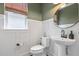 Cozy powder room with white wainscoting, green paint, and a pedestal sink at 518 Sound Dr, Summerville, SC 29486