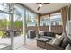 Cozy sunroom featuring comfortable seating, ceiling fan, and views of the outdoor space at 518 Sound Dr, Summerville, SC 29486
