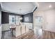 Chic dining area featuring modern chandelier, a decorative dark painted accent wall, and light-colored flooring at 533 Richfield Way, Summerville, SC 29486