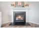 Close-up of the fireplace featuring white mantle, mirror decor, and a black hearth at 533 Richfield Way, Summerville, SC 29486