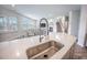Kitchen featuring a stainless steel sink, faucet, and bar with view of the dining and living area at 533 Richfield Way, Summerville, SC 29486