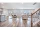 Open-concept living area with natural light, and a view of a staircase, dining area and outdoor space at 533 Richfield Way, Summerville, SC 29486