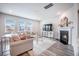 Bright living room boasts hardwood floors, large windows, and cozy fireplace with couches and modern decor at 533 Richfield Way, Summerville, SC 29486