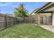 Spacious backyard with lush green grass and a wood fence for added privacy at 5737 Dewsbury Ln, North Charleston, SC 29418