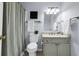 Bathroom featuring a shower with a curtain, single sink vanity, and tiled floor at 5737 Dewsbury Ln, North Charleston, SC 29418