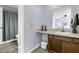 Bathroom features a single sink vanity and a peek at the toilet and shower behind a door at 5737 Dewsbury Ln, North Charleston, SC 29418