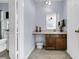 Bathroom view features a single sink vanity with storage and a toilet behind an open door at 5737 Dewsbury Ln, North Charleston, SC 29418