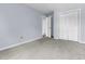 Bedroom featuring carpeted floors, a closet with bi-fold doors, and light blue painted walls at 5737 Dewsbury Ln, North Charleston, SC 29418