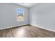Bedroom featuring wood flooring and a window with natural light at 5737 Dewsbury Ln, North Charleston, SC 29418