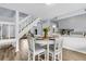 Bright dining area with white wooden table and chairs next to the staircase at 5737 Dewsbury Ln, North Charleston, SC 29418