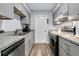 Well-lit kitchen featuring stainless steel appliances, gray cabinets, and granite countertops at 5737 Dewsbury Ln, North Charleston, SC 29418