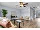 Inviting living room with stylish decor, wood floors, and a ceiling fan at 5737 Dewsbury Ln, North Charleston, SC 29418
