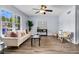 Bright living room featuring wood floors, lots of natural light, and a decorative ceiling fan at 5737 Dewsbury Ln, North Charleston, SC 29418