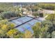 Aerial view of multiple outdoor tennis courts, a wonderful amenity for sports enthusiasts within the community at 5737 Dewsbury Ln, North Charleston, SC 29418