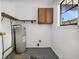 Utility room with water heater, shelving, and a window overlooking the neighbor's house at 5737 Dewsbury Ln, North Charleston, SC 29418