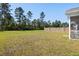 Expansive backyard featuring lush green grass, mature trees and a wooden privacy fence at 603 Yellow Leaf Ln, Summerville, SC 29486