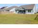 Fenced backyard showing green grass, blue siding on house and a screened patio at 603 Yellow Leaf Ln, Summerville, SC 29486