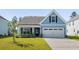 Charming blue home featuring a two-car garage and well-manicured front lawn at 603 Yellow Leaf Ln, Summerville, SC 29486