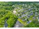 An aerial shot displays homes nestled around a scenic pond, complemented by mature trees and landscaping at 606 Knowledge Dr, Ladson, SC 29456