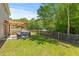 Secluded backyard featuring a pergola with seating, a grill, and a wooded perimeter at 606 Knowledge Dr, Ladson, SC 29456