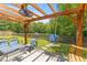 Backyard with a pergola, ceiling fan, swing and seating area overlooks a green lawn and a water feature at 606 Knowledge Dr, Ladson, SC 29456