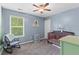 Light-filled bedroom showcasing a rocking chair, window with blinds, and crib at 606 Knowledge Dr, Ladson, SC 29456