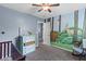 Bedroom showcasing a woodland mural, neutral carpet, and a crib at 606 Knowledge Dr, Ladson, SC 29456