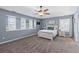 A cozy bedroom with plush carpet, neutral palette, and a ceiling fan for comfort at 606 Knowledge Dr, Ladson, SC 29456
