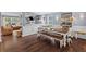 Bright dining area with wood floors, a long dining table, and open access to the living room at 606 Knowledge Dr, Ladson, SC 29456