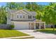 Charming two-story home with a well-maintained lawn, inviting front porch, and two-car garage at 606 Knowledge Dr, Ladson, SC 29456