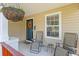 Cozy front porch featuring cushioned chairs and a hanging plant, perfect for relaxing at 606 Knowledge Dr, Ladson, SC 29456