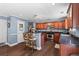 The kitchen with a breakfast bar has dark hardwood floors, stainless appliances and recessed lighting at 606 Knowledge Dr, Ladson, SC 29456