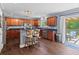 Eat-in kitchen boasts dark hardwood floors, stainless appliances, and a sliding glass door to the deck at 606 Knowledge Dr, Ladson, SC 29456