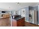 This kitchen features stainless steel appliances, granite countertops and overlooks the spacious living room at 606 Knowledge Dr, Ladson, SC 29456