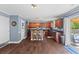 An eat-in kitchen with dark hardwood floors, stainless appliances, and a sliding glass door leading to a deck at 606 Knowledge Dr, Ladson, SC 29456