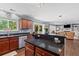 Open concept kitchen with stainless steel appliances, dark granite countertops and seamless access to the living room at 606 Knowledge Dr, Ladson, SC 29456