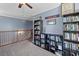 Open loft space with built-in bookcases and a view of the staircase at 606 Knowledge Dr, Ladson, SC 29456