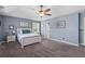 A bright main bedroom with carpet flooring, neutral walls, and a comfy bed, perfect for relaxation at 606 Knowledge Dr, Ladson, SC 29456