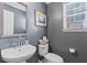 This powder room features a sleek white vessel sink, decorative mirror, and natural light from the window at 606 Knowledge Dr, Ladson, SC 29456