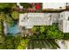 An aerial view of this home highlights the mature landscaping and the backyard pool at 62 Society St, Charleston, SC 29401