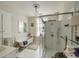 Well-lit bathroom featuring a clawfoot tub and glass enclosed shower at 62 Society St, Charleston, SC 29401
