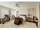 Bright bedroom with a dark wood sleigh bed and a ceiling fan at 62 Society St, Charleston, SC 29401