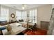 Bright bedroom with two twin beds, hardwood floors, and a ceiling fan at 62 Society St, Charleston, SC 29401