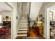 Grand foyer with staircase, hardwood floors, and antique furnishings at 62 Society St, Charleston, SC 29401
