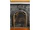 Close-up of a marble fireplace with an ornate gold screen at 62 Society St, Charleston, SC 29401